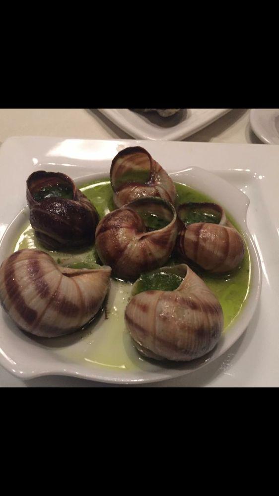 Escargot · Baked snails with garlic, butter and fresh herbs. Gluten free.