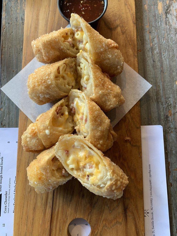 8 Pieces Bacon Mac and Cheese Egg Rolls · Ditalini pasta, jack and cheddar queso and bacon! Served with monterey jack and cheddar cheese queso.