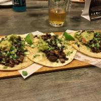3 Pieces Carne Asada Tacos · Marinated grilled flank steak, guacamole, diced onions and cilantro folded in grilled corn t...