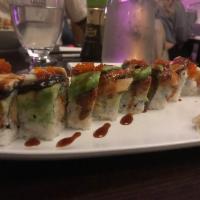 Green Monster Roll · Inside: shrimp tempura, cucumber. On top unagi, avocado, tobiko, eel and sauce. 