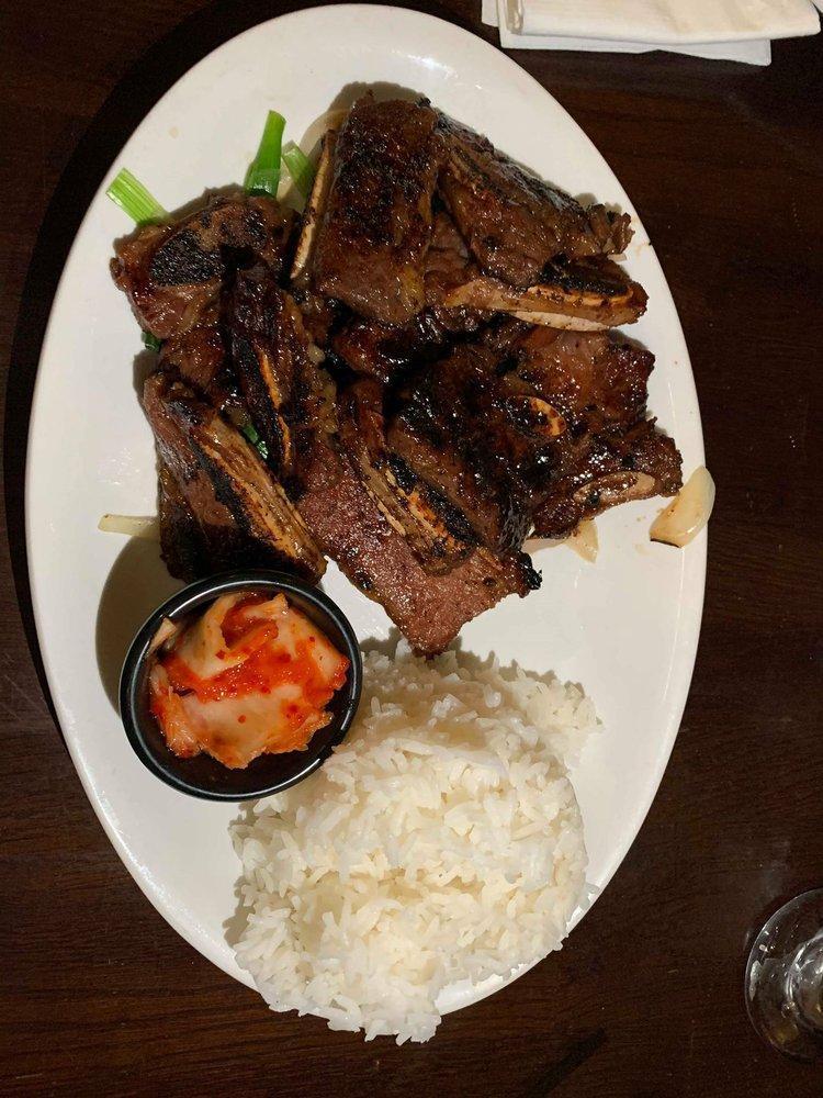 Korean BBQ Galbi · Prime beef short ribs with bones, marinated in a traditional Korean recipe and seared to perfection. Served with choice of white or brown rice. 