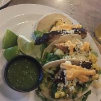 Blackened Fish Tacos · Blackened grouper, lettuce, flour tortilla, mango salsa, queso fresco, Served with a side of...
