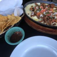 Queso Fundido · Cheese fondue served with corn or flour tortillas, salsa de arbol, pico de gallo and choice ...
