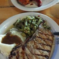 Pork Chops · Two 5 oz. chops grilled, blackened or fried, mashed potatoes, brown gravy, and green beans.