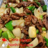 Beef Pepper Steak · Tender beef strips with diced onion and bell pepper stir fried in brown sauce. Served with r...