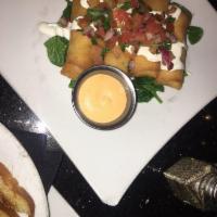 Mini Chimis · 4 crispy chimis stuffed with grilled chicken. Topped with pico de gallo, and sour cream. Ser...