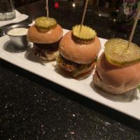 Nashville Hot Chicken Sliders · 3 hot sauce drenched chicken sliders topped with chopped Romaine and a pickle. Served with a...