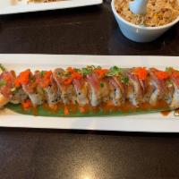 Dream Roll · Shrimp tempura, avocado, cream cheese, salmon, topped with seared tuna, sesame seeds and mas...