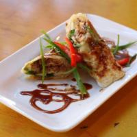 Duck Roll · Roti wrapped deep-fried duck. Scallions and cucumber serve with special sauce.