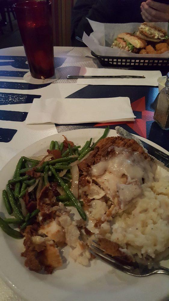 Chicken Fried Chicken · Huge all-natural chicken breast hand breaded and fried to golden perfection and smothered in our country gravy. Served with garlic whipped mashed potatoes and sauteed green beans with bacon and onions.