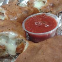Stromboli · Fresh baked pizza dough rolled and stuffed with pepperoni, salami, ham, extra mozzarella che...