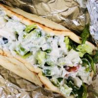 Lamb Gyro Sandwich · served in a pita with lettuce, tomato, onion, cucumber, white sauce, and hot sauce.