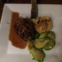Filet Mignon · Grilled filet mignon medallion served on a tamarindo sauce with chickpea puree, brussel spro...