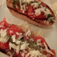 Bruschetta · Oven roasted tomatoes with basil pesto served on oven baked crostini and extra virgin olive ...