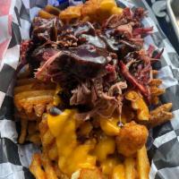 Brisket Poutine · Our award-winning brisket, chopped and piled high over a bed of fried mozzarella cheese curd...