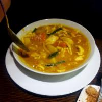 Coconut Curry Chicken · Mild. Sliced chicken breast, onion, carrot, and potato in our creamy yellow curry sauce topp...
