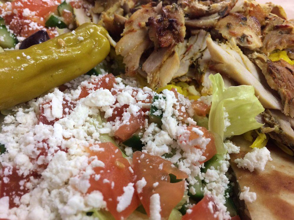Shawarma Plate · Served with yellow rice, Greek salad, hot pita and fresh cut marinated chicken. Tzatziki and vinaigrette on the side.