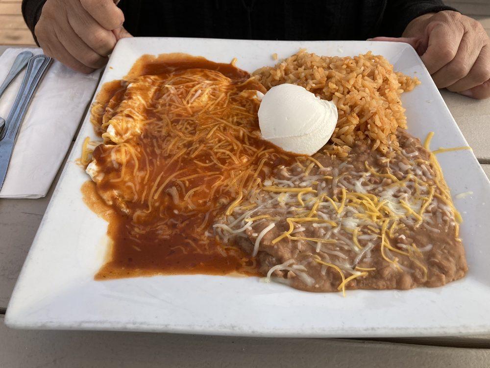 Huevos Rancheros · Corn tortillas topped with over medium eggs, homemade salsa, crema fresca sour cream and cheese, served with rice and beans and warm tortillas.