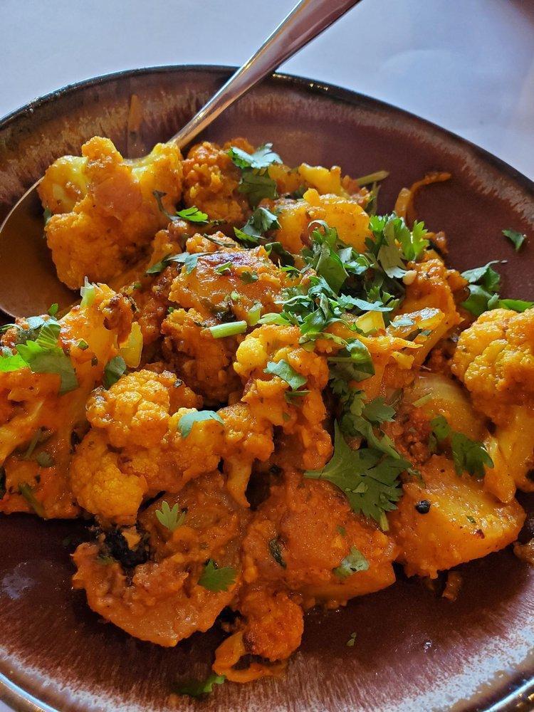 Aloo Gobi · Cauliflower and potato sauteed with caramelized onion, cumin, tamarind, and a hint of butter and garlic.