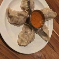 Chicken Momos Plate · Classic dumplings steamed or pan-seared. Served with our secret momo sauce.