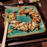 Rockin' Shrimp Tempura Roll · Deep-fried shrimp tempura, imitation crab, & avocado roll topped w/ spicy mayo & eel sauce.