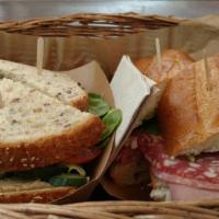 The Italian Sandwich · Soppresata, mortadella, salami, romaine, pepperoncini and Italian dressing on a rustic bague...