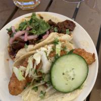 La Vaca Taco · Chipotle carne asada, black bean crema, pickled onions, and cilantro.