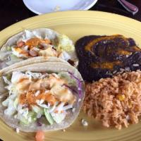 Fish Tacos · Two fried or grilled tilapia tacos on corn tortillas. Topped with lettuce, tomatoes, cheese ...
