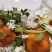 Spicy Buffalo Cauliflower · Fresh cauliflower florets buttermilk-battered and lightly fried, then tossed in housemade Sr...