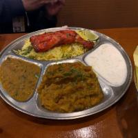 Tandoori Chicken · Fresh cut bone-in chicken marinated in yogurt with spices and topped with onions and bell pe...