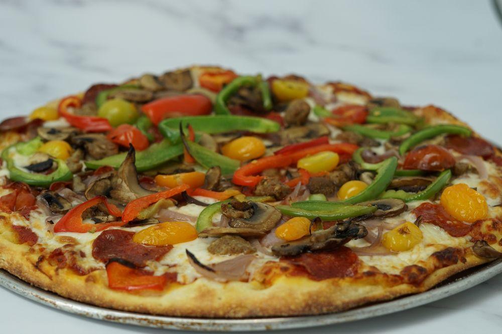 American Pizza · Housemade marinara sauce, mozzarella, natural pepperoni, fennel sausage, baby heirloom tomatoes, mushrooms, fresh bell peppers, roasted red onion.