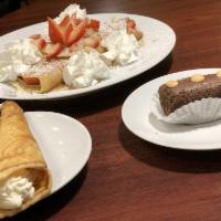 Strawberry Crepe · Topped with powdered sugar, whipped cream and syrup.