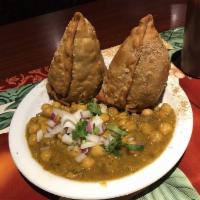 Samosa · 2  samosas spiced with green chilies and onions served with mint and tamarind chutney.