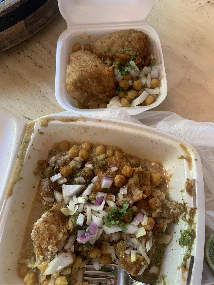 Samosa Chaat · Chopped samosa smothered with garbanzo beans and topped with yogurt, mint & tamarind chutney, onions, cilantro, and fresh ground spices.