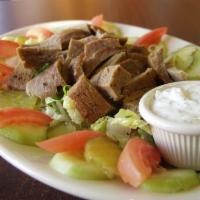 Shawarma Salad · Served on shredded lettuce, tomato, pickles, cucumbers and pepperoncini peppers.