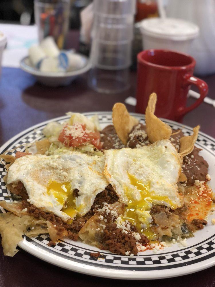 Chilaquiles · Corn tortillas cut in quarters and lightly fried, with green salsa, refried beans, Monterey Jack cheese, and eggs any style.