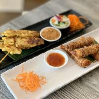 Satay · Marinated chicken seasoned and grilled to perfection served with peanut sauce and ajard-cucu...