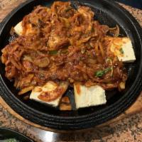 Kimchi Jigae · Traditional Korean kimchi stew with tofu, pork and rice cakes.