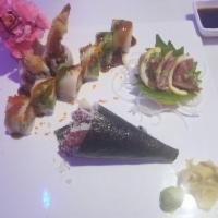 Sex on the Beach Roll · Shrimp tempura, spicy tuna inside, topped with white tuna, avocado, masago and eel sauce.