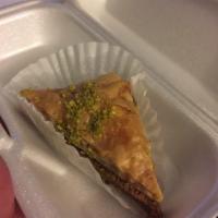 Baklava · Traditional Greek dessert of walnuts baked between layers of flaky filo dough and topped wit...