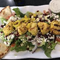 Grilled Chicken Salad · A hearty mixed green salad, tomatoes, onions, cucumbers, feta cheese, and Greek Kalamata oli...