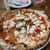 Margherita Pizza · Red pizza, mozzarella, olive oil and basil.