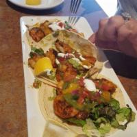 Blackened Shrimp Tacos · Pan seared blackened shrimp with shredded lettuce, creme fraiche, salsa verde, and mango sal...