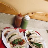 Carnitas Taco · Pulled pork, chop cilantro and onions, in a double corn tortilla with lime, cucumber and sal...