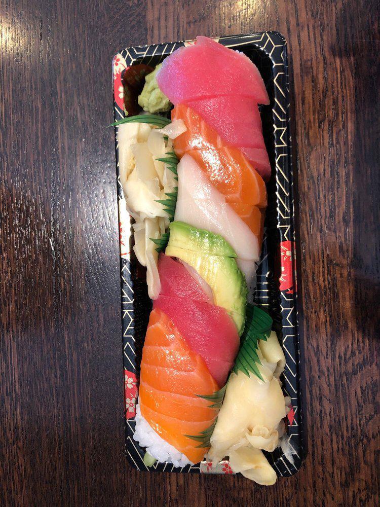 Rainbow Roll · Avocado, cucumber, and crab salad inside topped with tuna, salmon, and white tuna.