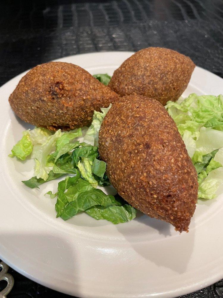 Kibbeh · Fried bulgur and meat shells stuffed with a mixture of (beef or chicken) onion, pine, nuts, and spices.