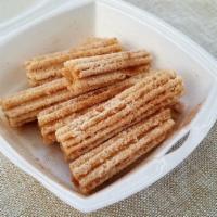 Churros · Traditional Mexican donuts dusted with a sweet cinnamon sugar and cut into bite size pieces