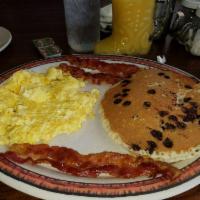 Wagon Wheel · 2 large eggs, 2 pancakes, bacon or sausage with toppings like pecan, blueberry, strawberry o...