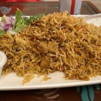 Chicken Biryani · Boneless chicken pieces marinated with herbs and spices. Cooked with basmati rice.