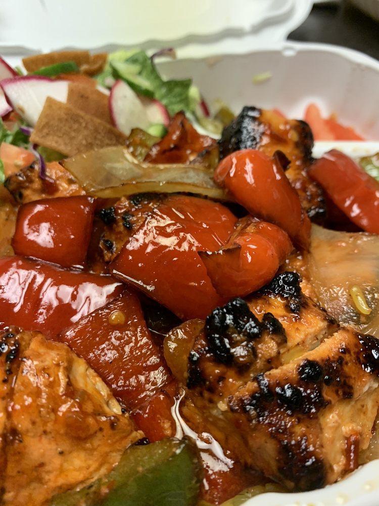 Spicy Chicken Kabob Plate · 7-piece skewer of chicken stir-fried with our magic lamp spicy sauce , onions, bell peppers and served with garlic sauce, cucumber pickles and tomatoes. 